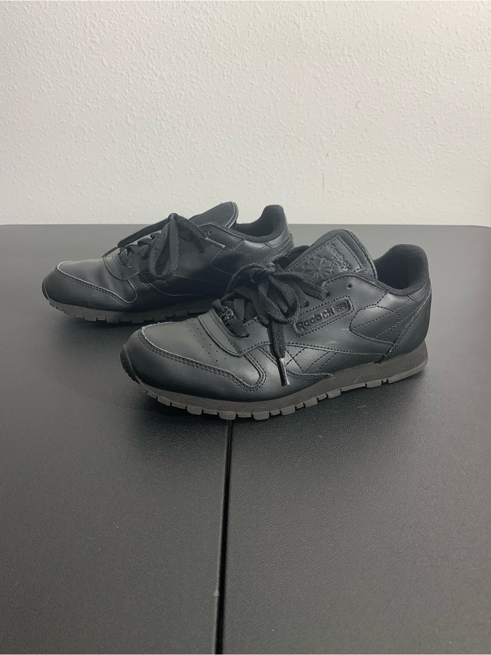 Womens Reebok All-Black Leather Sneakers
